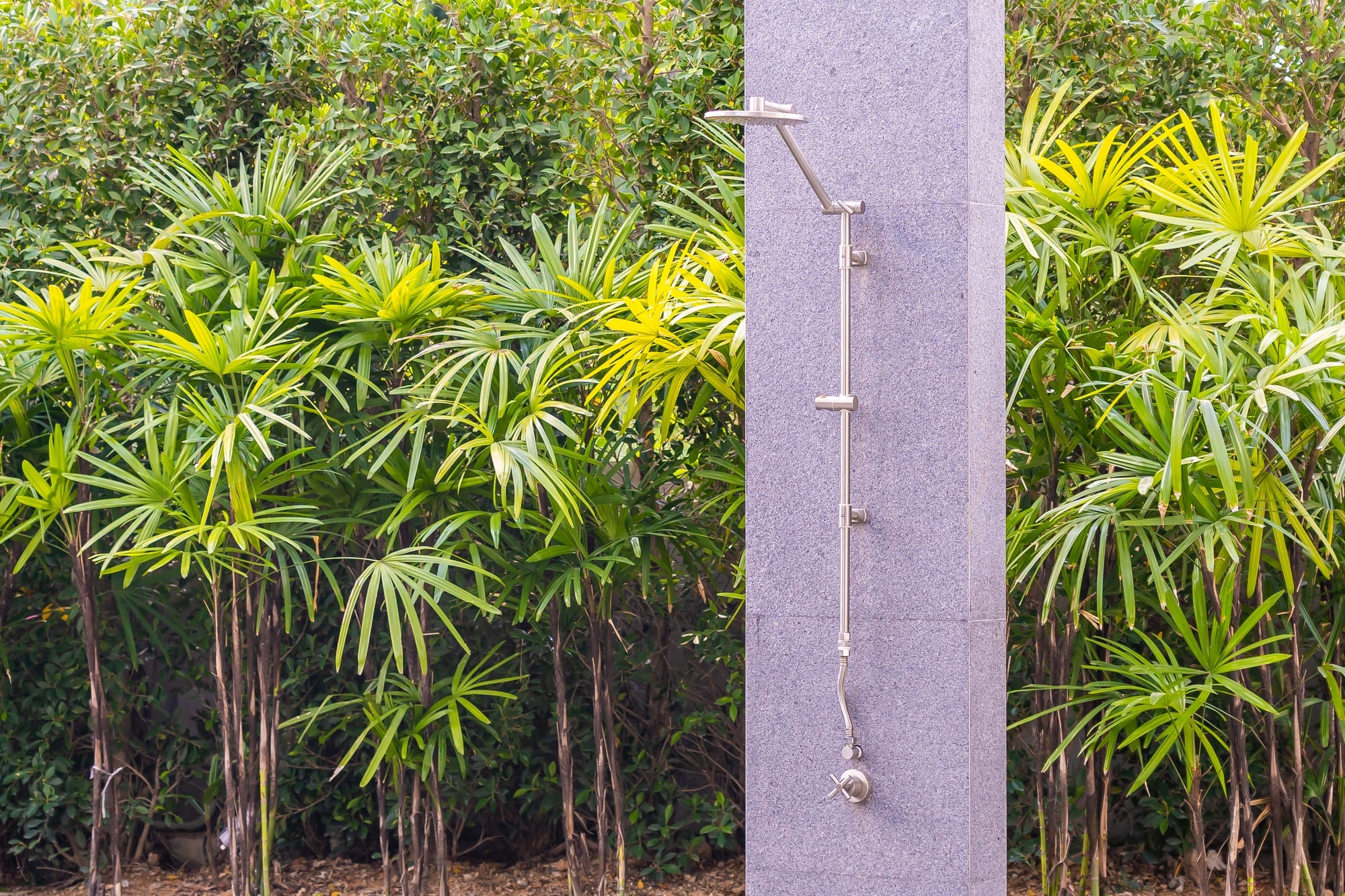 Beautiful outdoor shower surrounded by plants