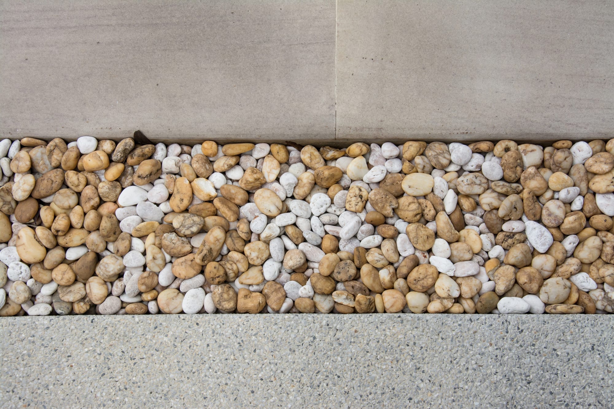 A walkway pattern made with pebble tiles.