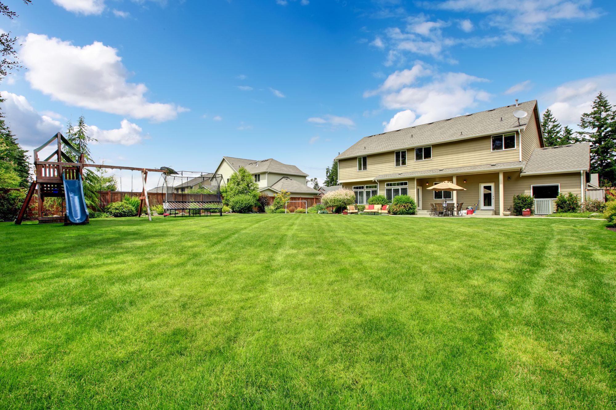 Large beautiful fenced backyard with play ground and nice house.